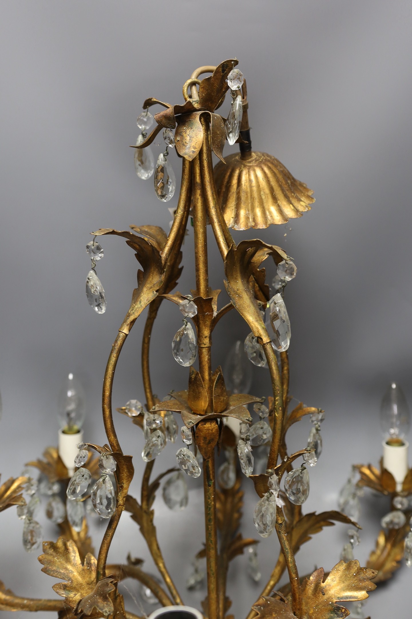 A French gilt metal and cut glass drop eight branch, electrolier, 58 cms high.